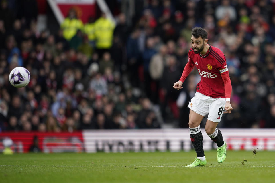 Manchester United's Bruno Fernandes scores his side's first goal during the English Premier League soccer match between Manchester United and Liverpool at the Old Trafford stadium in Manchester, England, Sunday, April 7, 2024. (AP Photo/Dave Thompson)