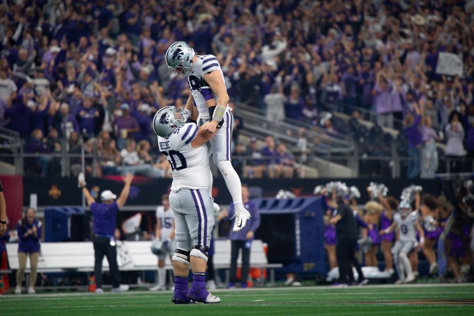 Dec 3, 2022; Arlington, TX, USA; Kansas State Wildcats offensive lineman Cooper Beebe (50) and quarterback Will Howard (18) celebrate during the game between the TCU Horned Frogs and the Kansas State Wildcats at AT&T Stadium. Mandatory Credit: Jerome Miron-USA TODAY Sports