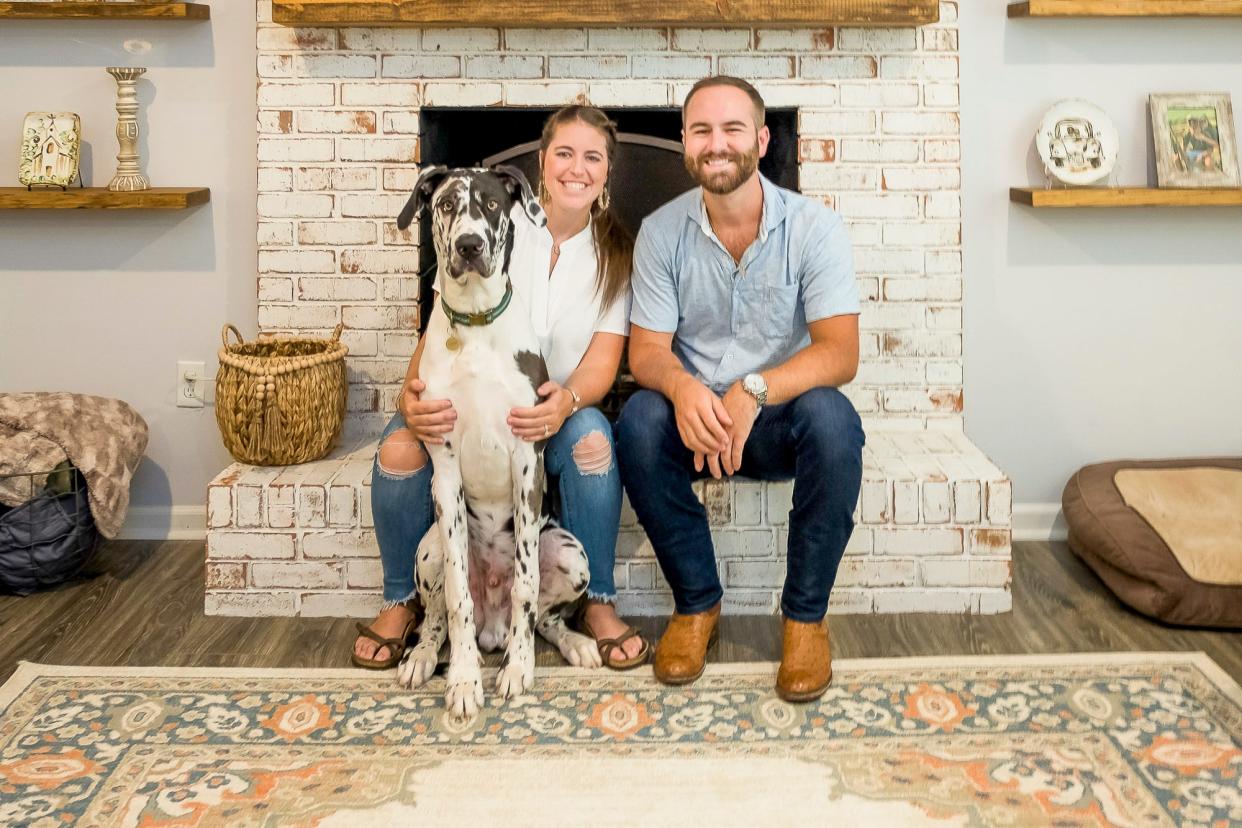 Bailey and Zac Lawrence and their canine companion, Cash, love their new home.