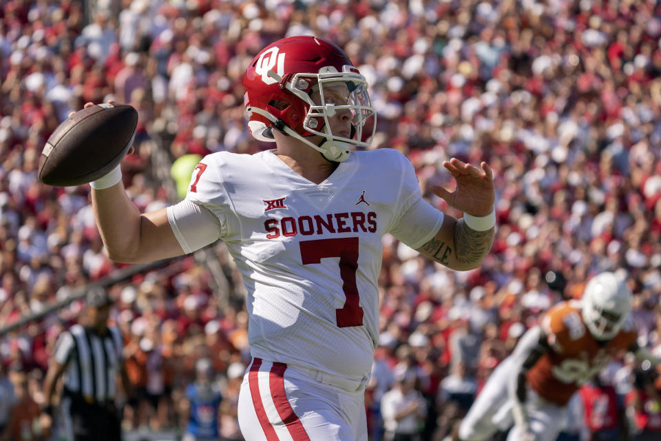 Oklahoma quarterback Spencer Rattler (7) throws downfield against Texas during the first half of an NCAA college football game at the Cotton Bowl, Saturday, Oct. 9, 2021, in Dallas. (AP Photo/Jeffrey McWhorter)