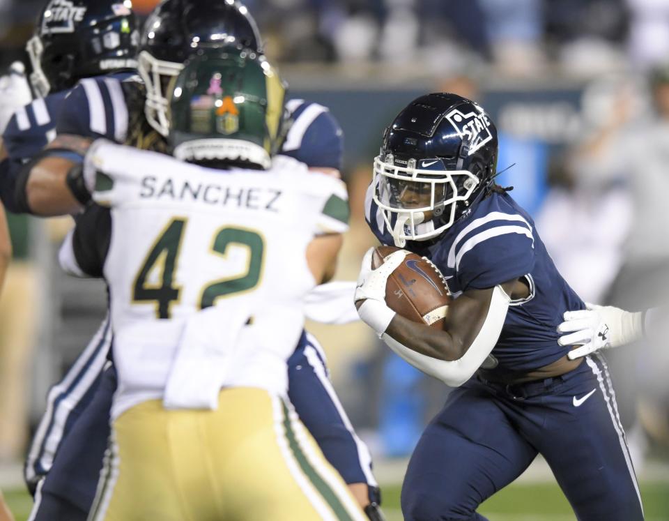 Utah State running back Davon Booth, right, carries the ball for a 22-yard touchdown against Colorado State during the first half of an NCAA college football game Saturday, Oct. 7, 2023, in Logan, Utah. | Eli Lucero/The Herald Journal via AP