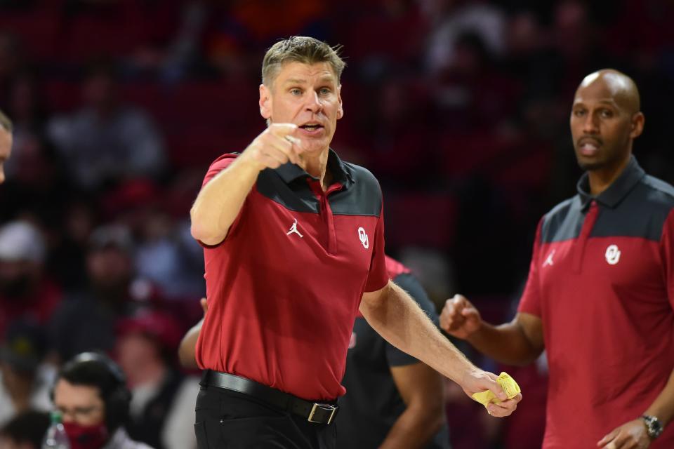 OU coach Porter Moser, left, earned his 300th career win Wednesday in a 74-67 win against Florida in Norman.