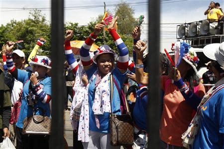 Anti-government protesters cheer as they arrive at an air force base in Bangkok May 15, 2014. REUTERS/Chaiwat Subprasom