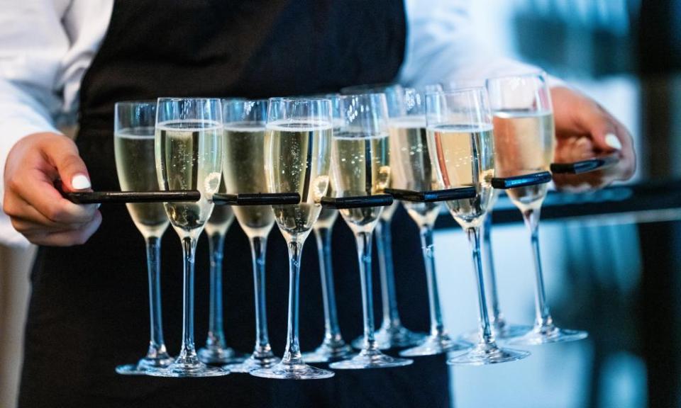 Close Up Of Waitress Serving Glasses Of Champagne At Event