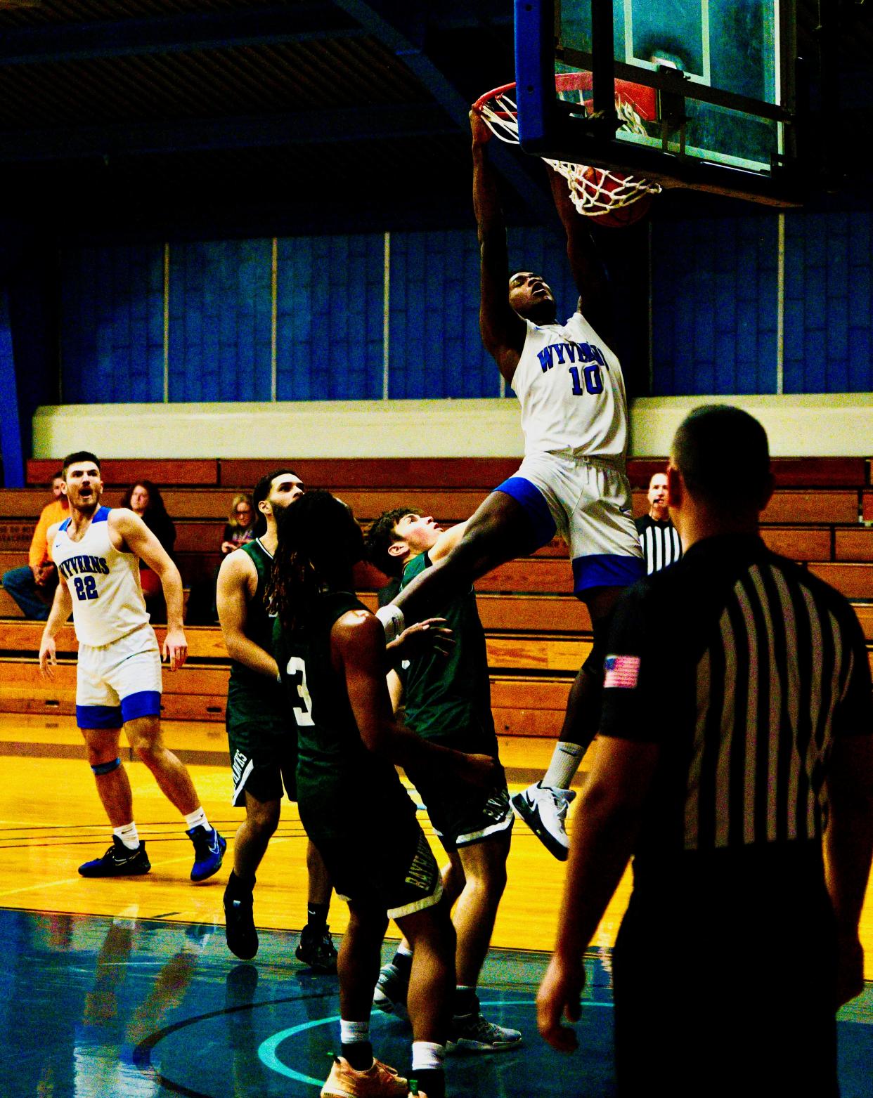 Former Worcester Tech standout Johnny Annan finishes off a slam dunk in a game earlier this season for Quinsigamond Community College