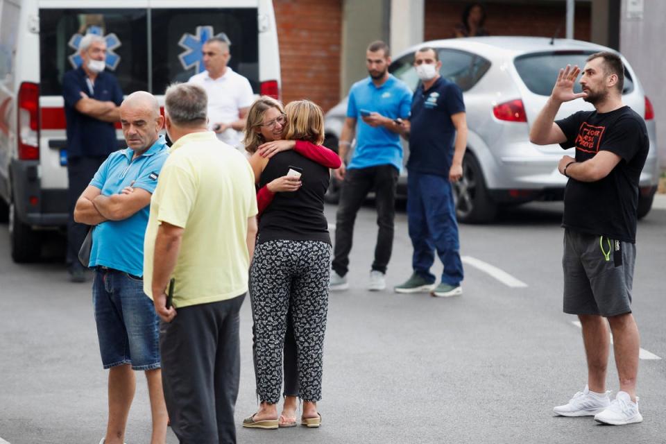 Relatives of victims wait in front of a city hospital after the shooting (Reuters)