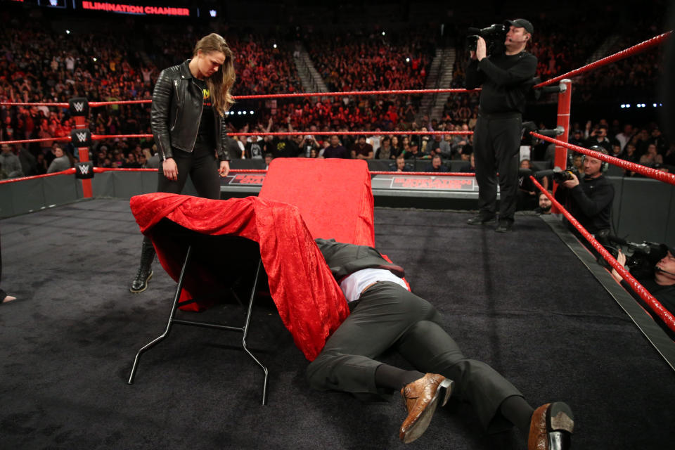 Ronda Rousey tossed Triple H through a table at WWE’s “Elimination Chamber” on Sunday night in Las Vegas. (Photo courtesy WWE)
