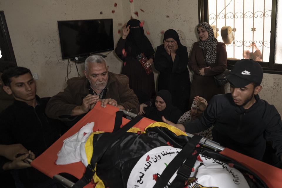 Relatives react during the funeral of Khalil Bahtini, the Islamic Jihad militant group's commander for the northern Gaza Strip, his wife and son, who were killed in an Israeli airstrike at their family home in Gaza City, Tuesday, May 9, 2023. Bahtini was among three senior Islamic Jihad commanders killed in targeted airstrikes early Tuesday. Palestinian health officials said at least 10 others were killed, including wives of two of the militants, several of their children and others nearby. (AP Photo/Fatima Shbair)