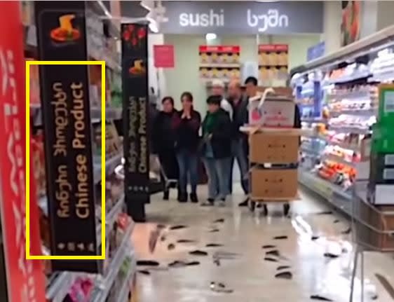 <span>A Georgian-language sign reading 'Chinese products' seen in the video</span>