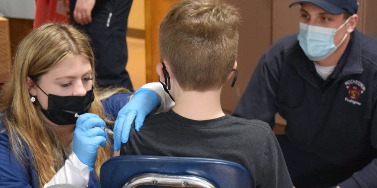 At a clinic at the Chamberlain Street School on Monday, UNH nursing students administered the vaccine after working with firefighters to set up a clinic in the school’s gymnasium.