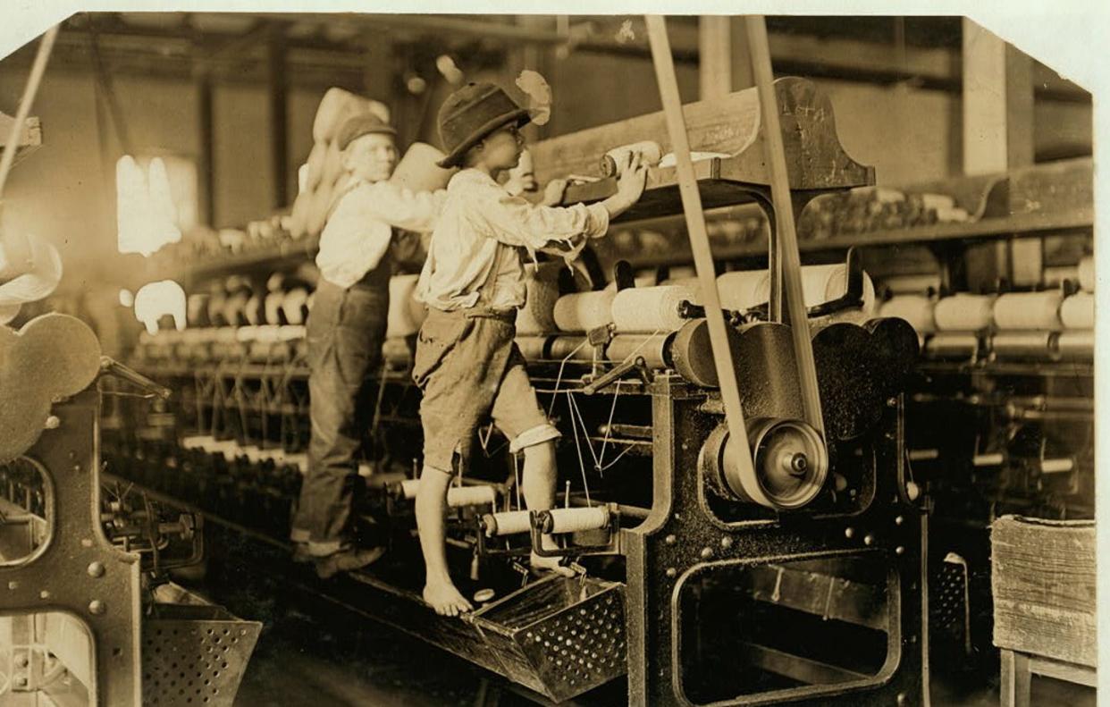 <span class="caption">These boys working in a Georgia cotton mill were photographed in 1909. </span> <span class="attribution"><a class="link " href="https://www.loc.gov/pictures/item/2018674998" rel="nofollow noopener" target="_blank" data-ylk="slk:Lewis Hine/The National Child Labor Committee Collection via Library of Congress;elm:context_link;itc:0;sec:content-canvas">Lewis Hine/The National Child Labor Committee Collection via Library of Congress</a></span>