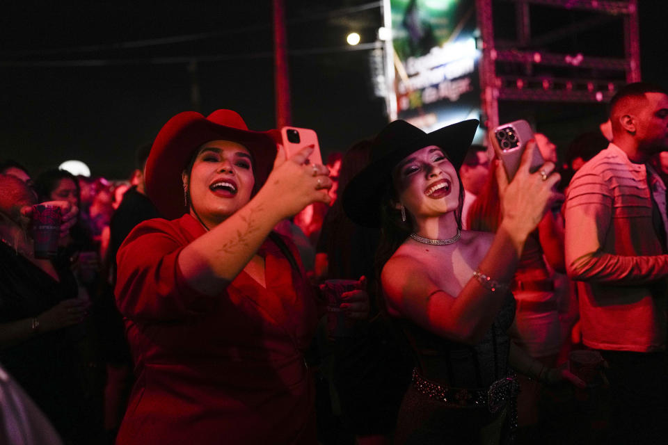 Spectators attend a concert at the ExpoZebu fair in Uberaba, Minas Gerais state, Brazil, Saturday, April 27, 2024. Uberaba holds an annual gathering called ExpoZebu that bills itself as the world’s biggest Zebu fair. (AP Photo/Silvia Izquierdo)