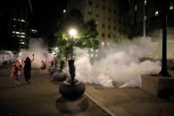 Tear gas canisters land as protesters walk past during nationwide unrest following the death in Minneapolis police custody of George Floyd, in Raleigh