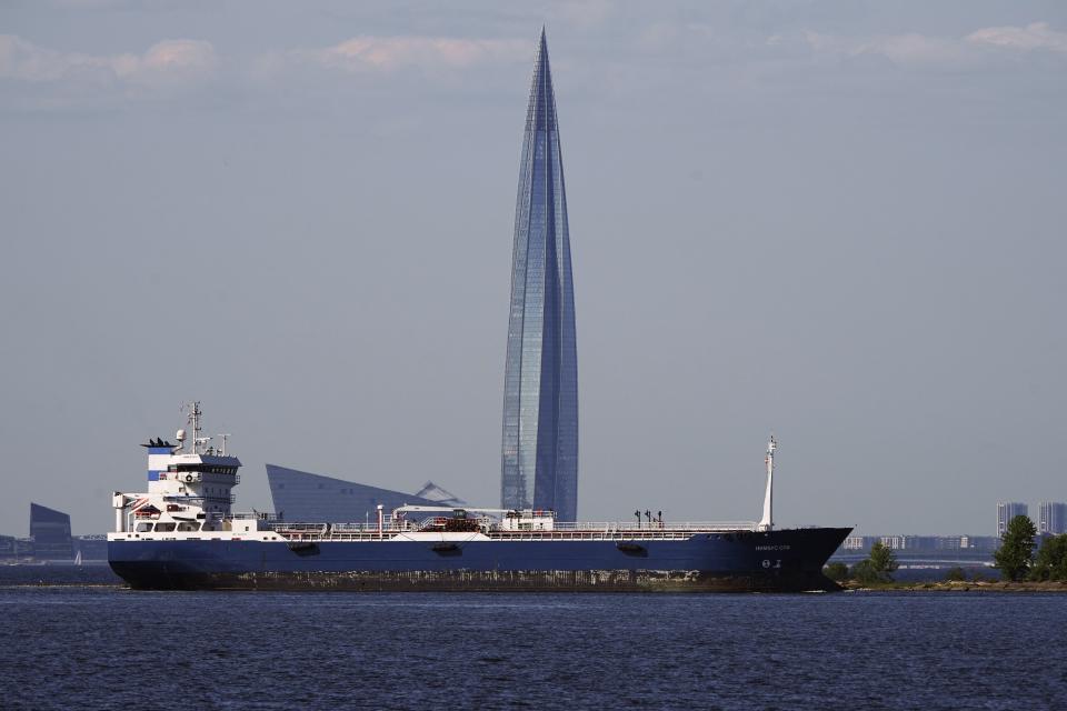 FILE - 'Nimbus SPB', an oil products tanker, floats in the Finnish Gulf past the Lakhta Center skyscraper, the headquarters of Russian gas monopoly Gazprom in St. Petersburg, Russia, on June 11, 2023. Prices for Russian oil have risen well above a price cap imposed by Western allies as part of sanctions over the invasion of Ukraine and that is putting the cap to its first serious test. The idea is to limit President Vladimir Putin's earnings from oil by barring Western insurers and shippers from handling oil above $60 per barrel. (AP Photo, File)