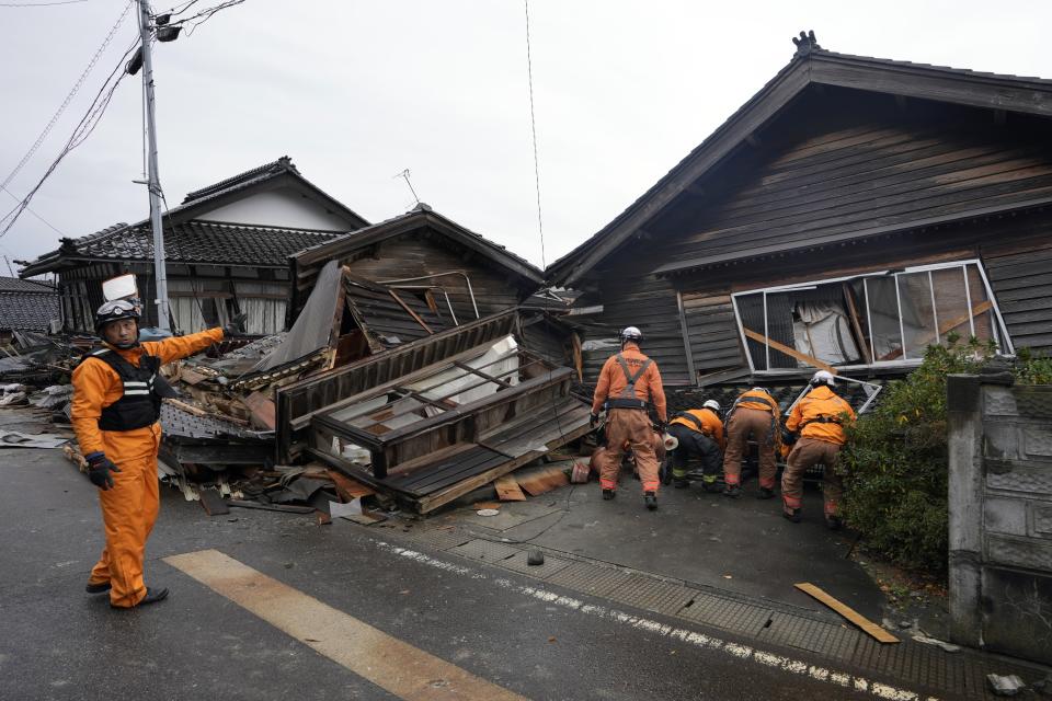 Rescue workers search a collapsed house caused by powerful earthquake in Suzu, Ishikawa Prefecture Wednesday, Jan. 3, 2024. (AP Photo/Hiro Komae)