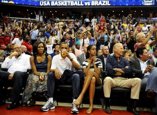 This file photo shows US President Barack Obama with his wife Michelle, daughter Malia, and Vice President Joe Biden, as the US Senior Men's National Team and Brazil play during a pre-Olympic exhibition basketball game at the Verizon Center, on July 16, in Washington, DC