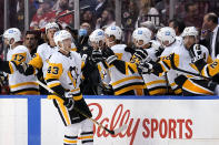 Pittsburgh Penguins center Danton Heinen (43) is congratulated after scoring a goal during the second period of the team's NHL hockey game against the Florida Panthers, Thursday, Oct. 14, 2021, in Sunrise, Fla. (AP Photo/Lynne Sladky)
