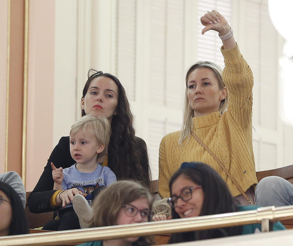 An opponent of a measure to toughen the rules for vaccination exemptions gives a thumbs down as the bill's author, state Sen. Richard Pan, D-Sacramento, makes his closing statements Wednesday, May 22, 2019, in Sacramento, Calif. The Senate approved the bill, SB276, that gives state public health officials instead of local doctors the power to decide which children can skip their shots before attending school. The bill now goes to the Assembly.(AP Photo/Rich Pedroncelli)