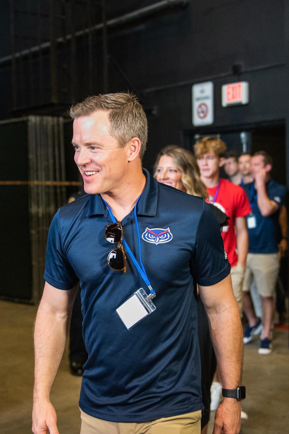 Florida Atlantic men's basketball head coach Dusty May walks to the the stage at the Mizner Park Amphitheater on Wednesday, April 19, 2023, in Boca Raton, Fla. Hundreds of Florida Atlantic fans gathered in Mizner Park to celebrate the FAU men's basketball team's accomplishments during the 2022-2023 season, including an appearance in the NCAA Tournament Final Four.