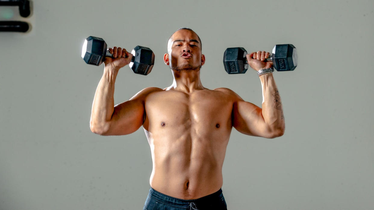  Man doing a dumbbell workout. 