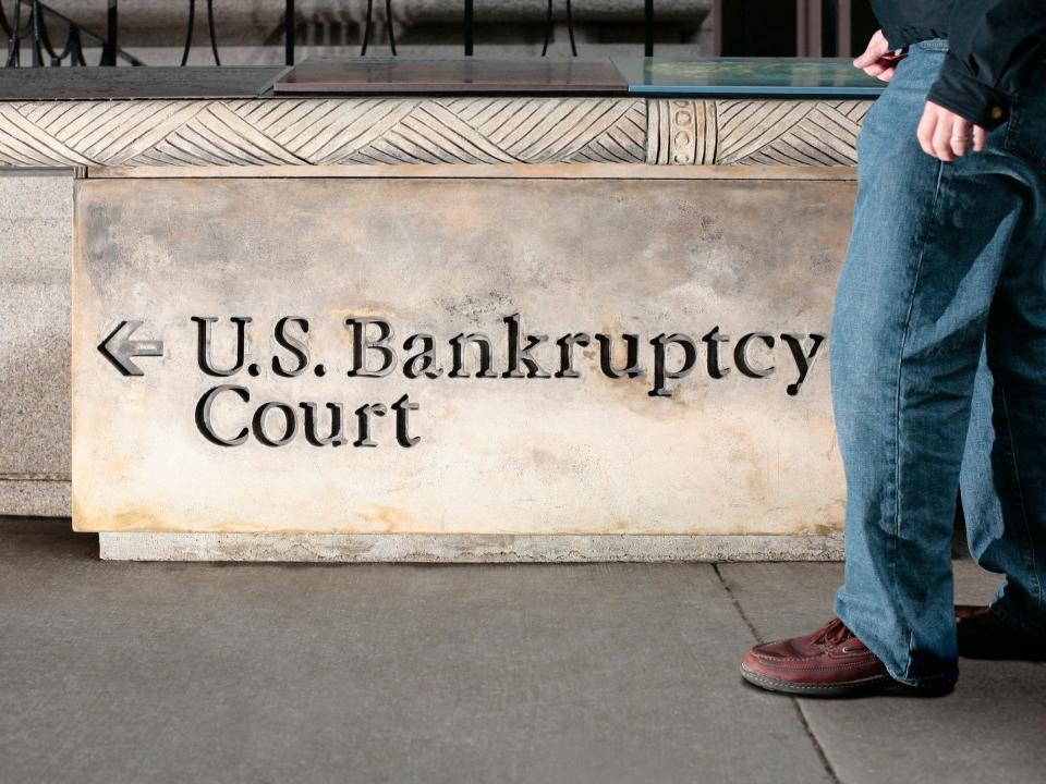 A man walks in front of a United States Bankruptcy Court sign in New York City.