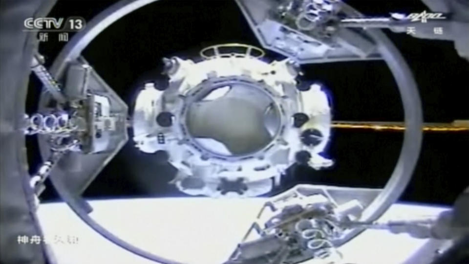 In this image taken from video footage run by China's CCTV, the docking process in space between the Tianhe core module of China's space station and a Shenzhou-12 spaceship carrying a crew of Chinese astronauts is seen, Thursday, June 17, 2021. The spaceship has docked with China's new space station at the start of 3-month mission, marking a milestone in the country's ambitious space program. (CCTV via AP Video)