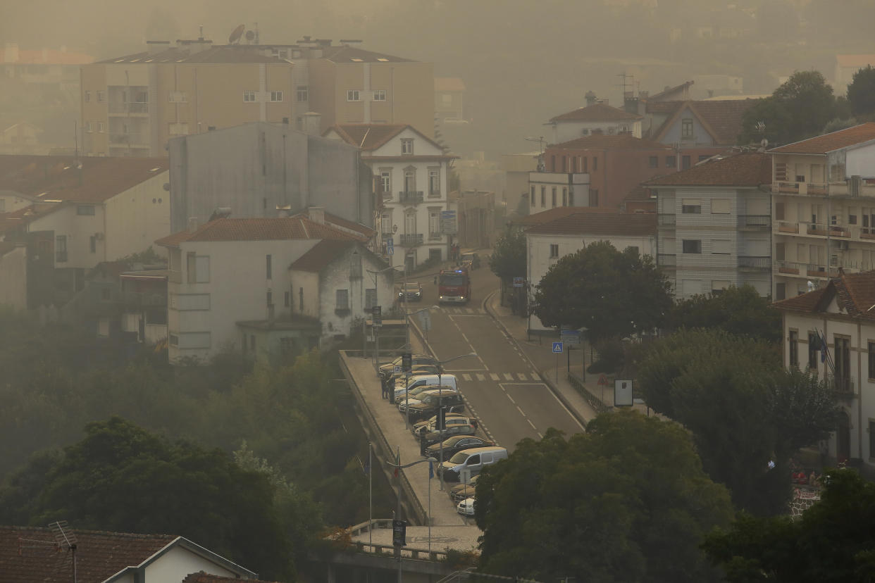 Smoke fills the air in Sever do Vouga, a town in northern Portugal that has been surrounded by forest fires, Monday, Sept. 16, 2024. (AP Photo/Bruno Fonseca)