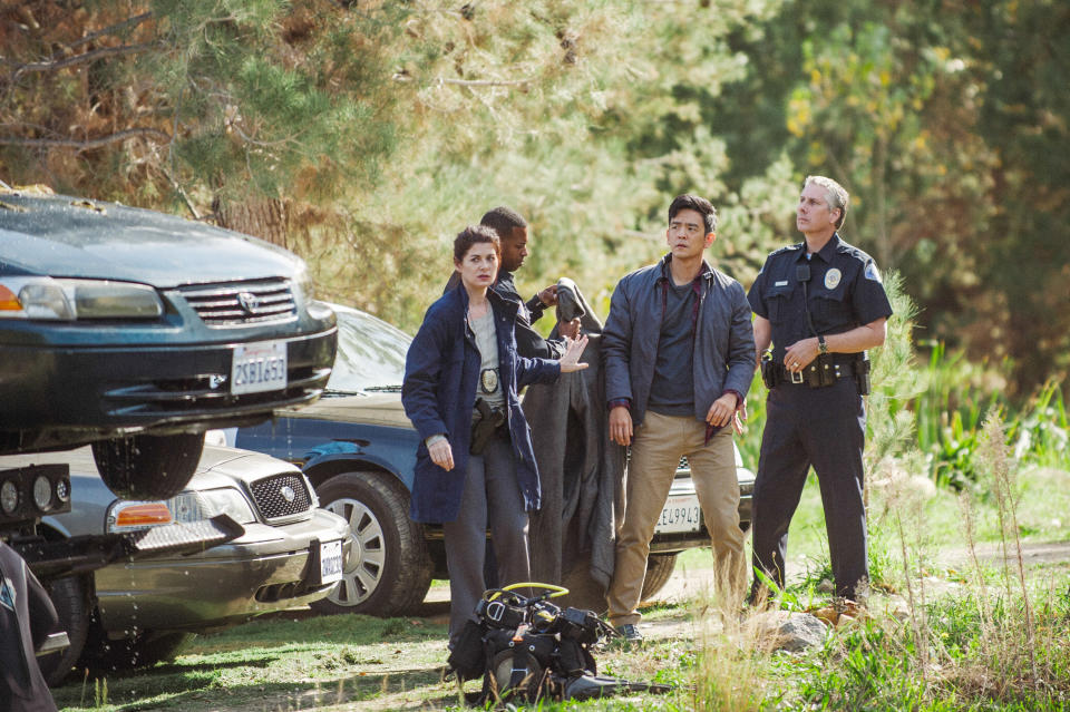 A police detective arrests a man