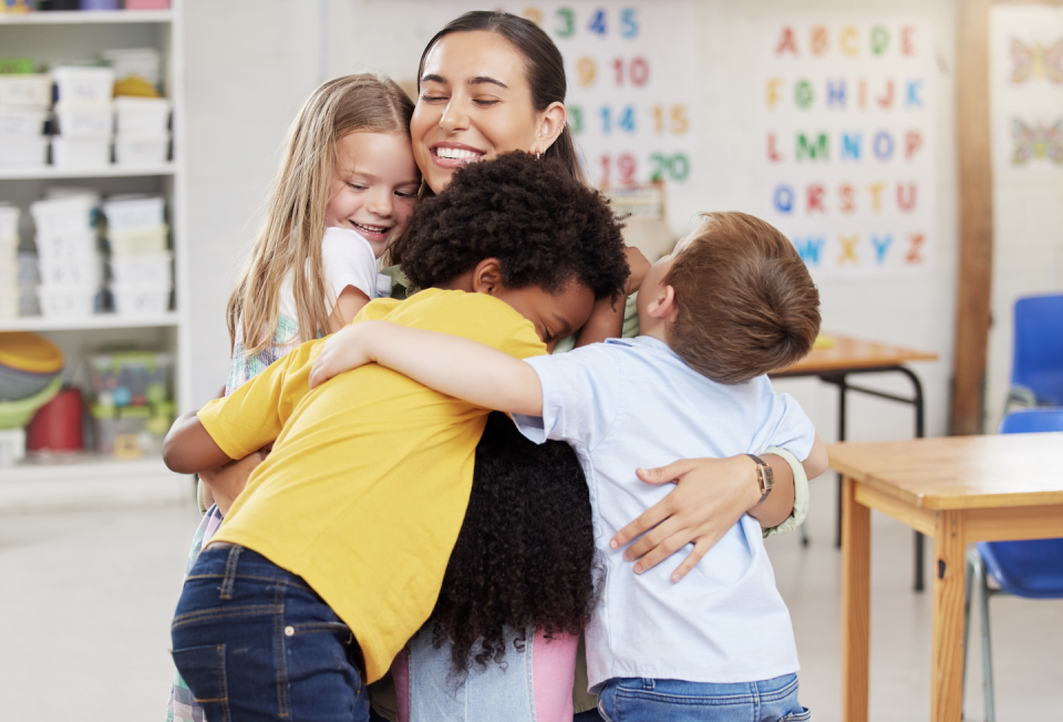 a person kissing a couple of children