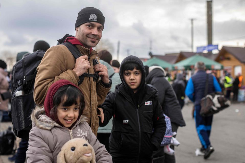 Afghan refugee Ajmal Rahmani and his children, now fleeing the conflict in Ukraine, arrive in eastern Poland on Feb. 27, 2022.