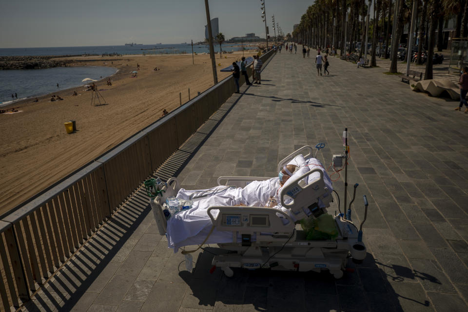 Francisco Espana, 60, looks at the Mediterranean sea from a promenade next to the "Hospital del Mar" in Barcelona, Spain, Friday, Sept. 4, 2020. Francisco spent 52 days in the Intensive Care unit at the hospital due to coronavirus, but today he was allowed by his doctors to spend almost ten minutes at the seaside as part of his recovery therapy. (AP Photo/Emilio Morenatti)