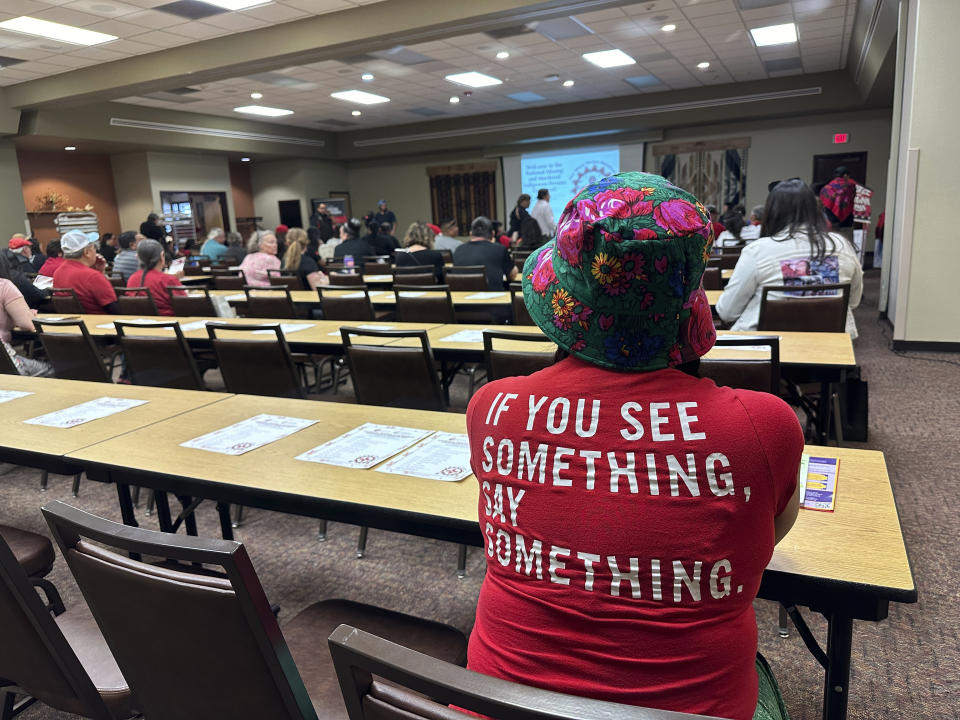 A crowd gathered at the Indian Pueblo Cultural Center for Missing and Murdered Indigenous Persons Day in Albuquerque, N.M., Sunday, May 5, 2024. Many wore red shirts and shawls, a color synonymous with raising awareness about the disproportionate number of Indigenous people who have been victims of violence. (AP Photo/Susan Montoya Bryan)