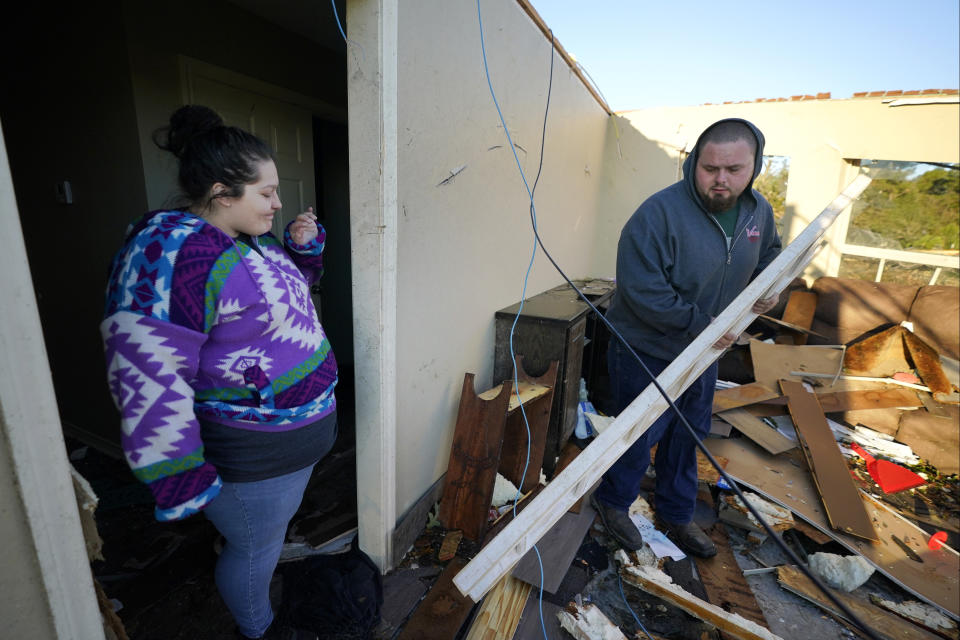 Nathan Dooley, right, and his wife Sydnie Dooley look for items to salvage after a tornado hit in Powderly, Texas, Saturday, Nov. 5, 2022. (AP Photo/LM Otero)