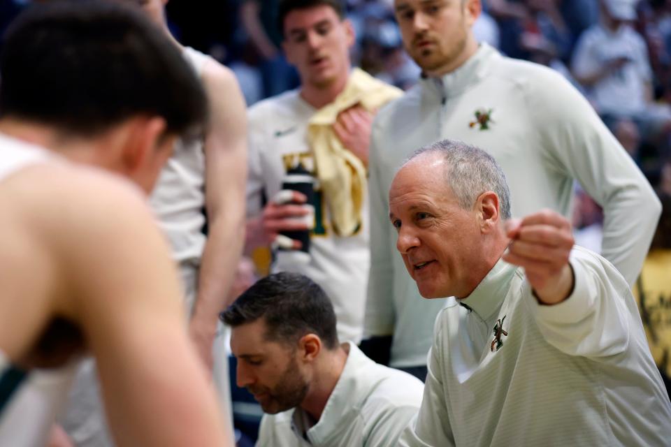 Vermont head coach John Becker talks to his team during a timeout in the first half against UMass Lowell in the final of the America East Conference Tournament, Saturday, March 11, 2023.