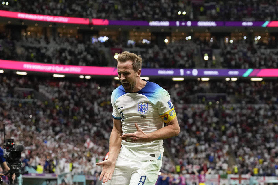 England's Harry Kane celebrates scoring his side's second goal during the World Cup round of 16 soccer match between England and Senegal, at the Al Bayt Stadium in Al Khor, Qatar, Sunday, Dec. 4, 2022. (AP Photo/Frank Augstein)