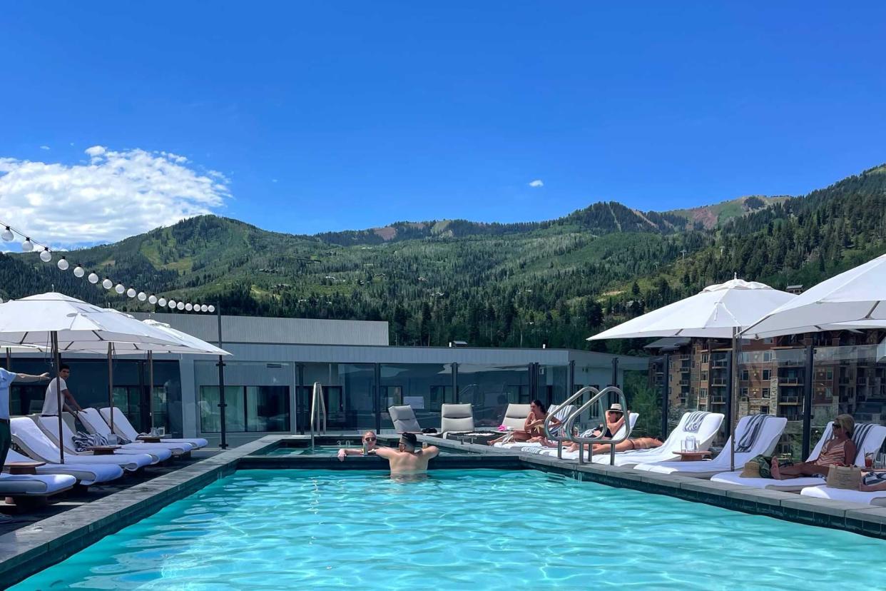 People lounge by pool at Pendry Hotel in Park City