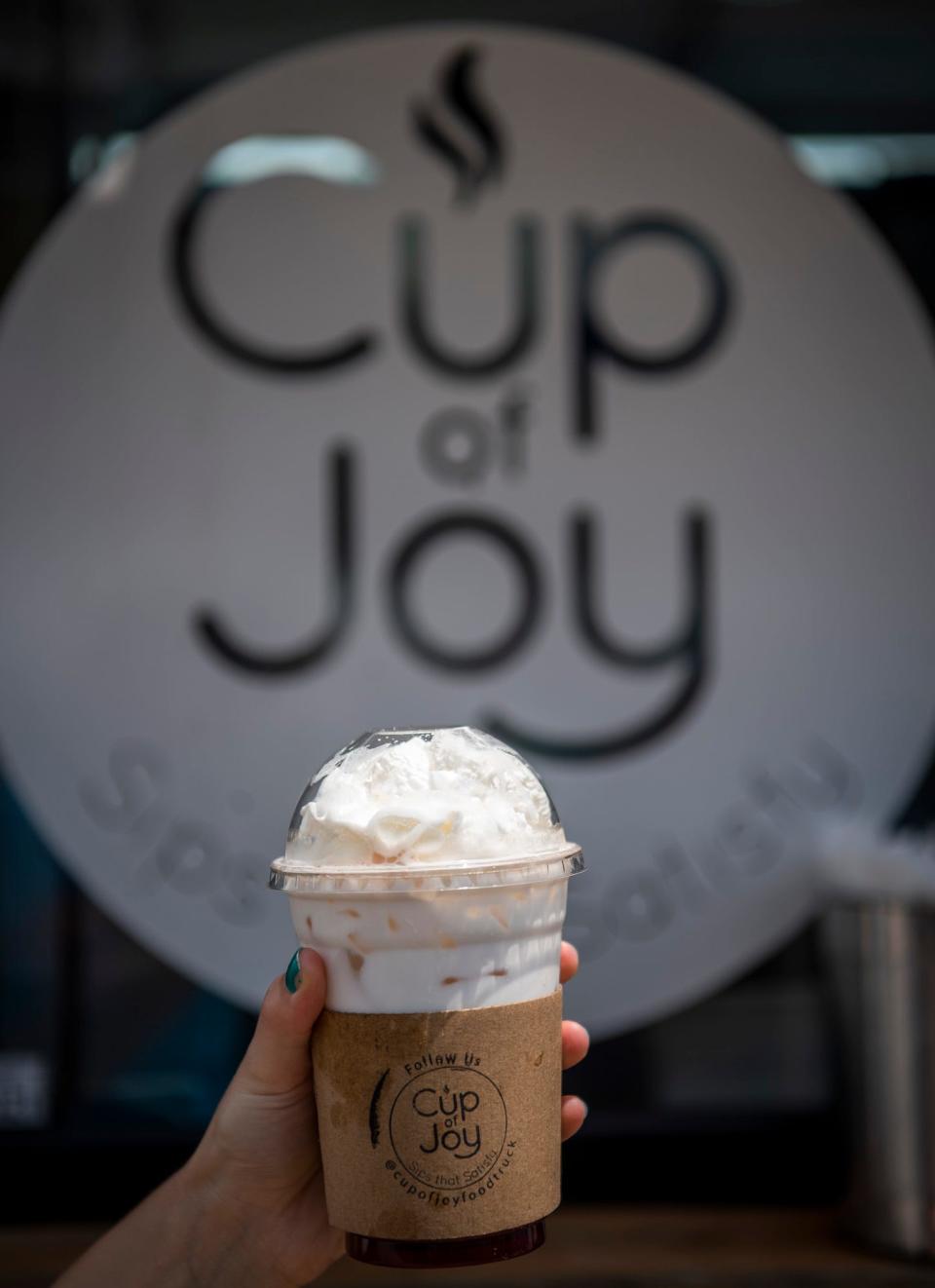 Herald-Times reporter Maya Gray holds a strawberry shortcake Italian cream soda from Cup of Joy at the Monroe County Fair at the Monroe County Fairgrounds on Monday, July 3, 2023.