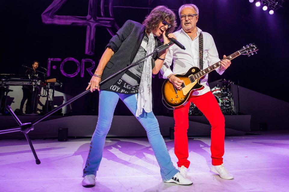 Kelly Hansen (L) and Mick Jones of the band Foreigner perform during their 40th Anniversary Tour at DTE Energy Music Theater on August 11, 2017 in Clarkston, Michigan.