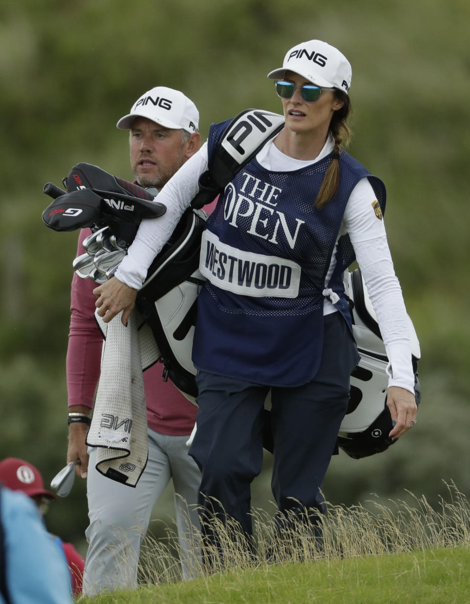 England's Lee Westwood with his caddie and girlfriend Helen Storey walk to the 5th green during the second round of the British Open Golf Championships at Royal Portrush in Northern Ireland, Friday, July 19, 2019.(AP Photo/Matt Dunham)