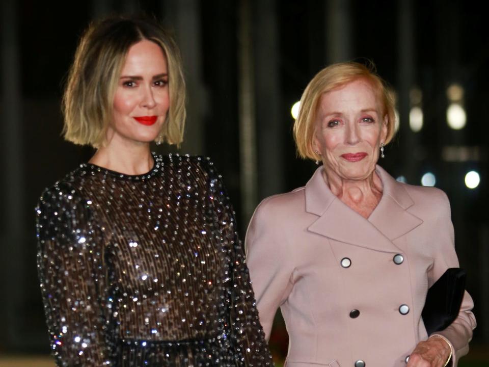 sarah paulson and holland taylor holding hands and posing for a photo at en event in 2021