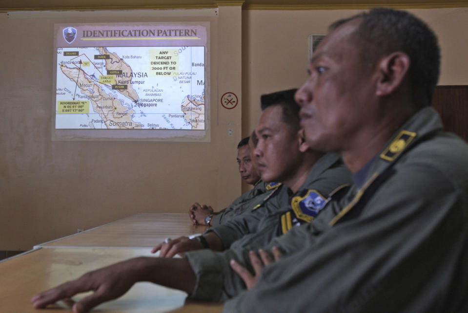 An operation map is displayed on the wall as Indonesian Air Force personnel listen to a briefing following to a search mission for the missing Malaysia Airlines Boeing 777 that was conducted over the Strait of Malacca, at Suwondo air base in Medan, North Sumatra, Indonesia, Wednesday, March 12, 2014. Malaysia asked India to join the expanding search for the missing jetliner near the Andaman Sea, far to the northwest of its last reported position and a further sign Wednesday that authorities have no idea where the plane might be more than four days after it vanished. (AP Photo/Binsar Bakkara)