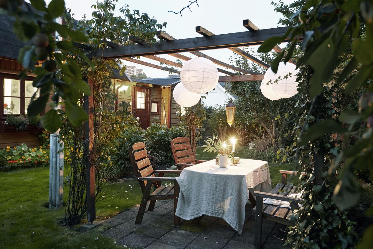 Table set in garden under pergola