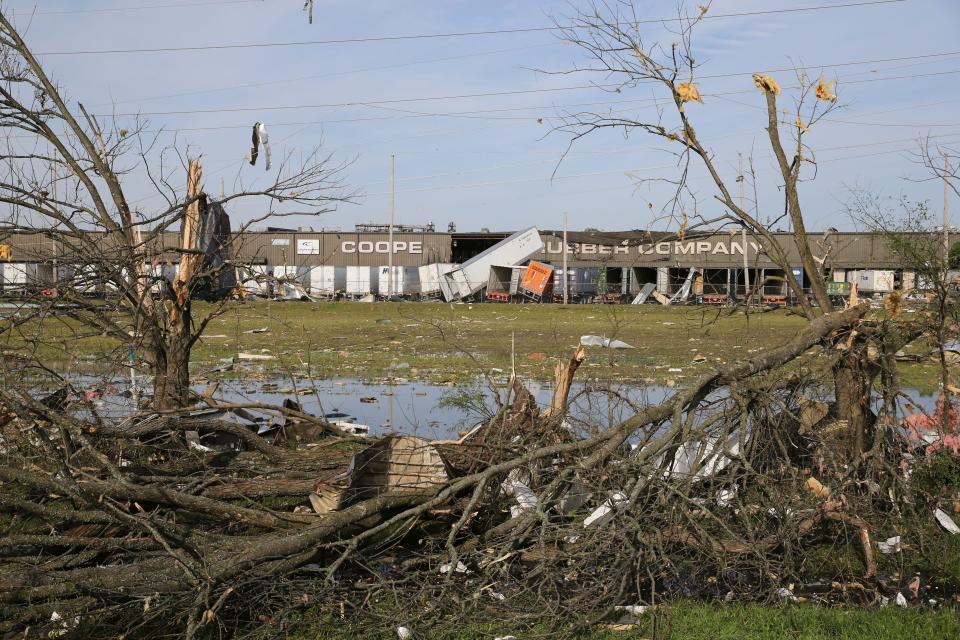 The broken and damaged trees along U.S. Hwy 45 South are covered with metal and other materials that were ripped off the nearby Cooper Tire and Rubber Company, on April 1, 2023, in Tupelo, Miss. Production at the large north Mississippi tire plant has ground to a halt in the wake of a damaging tornado, halting operations at the second-largest production facility for Goodyear’s North American network.