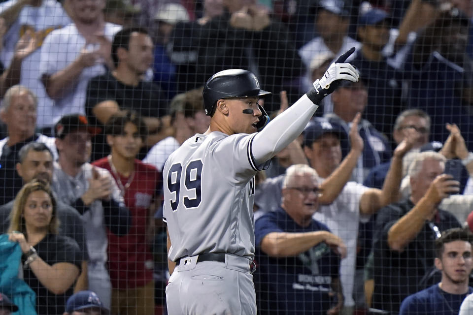 New York Yankees' Aaron Judge (99) celebrates after scoring on a three-run double by Gleyber Torres during the 10th inning of the team's baseball game against the Boston Red Sox, Tuesday, Sept. 13, 2022, in Boston. The Yankees won 7-6. (AP Photo/Steven Senne)