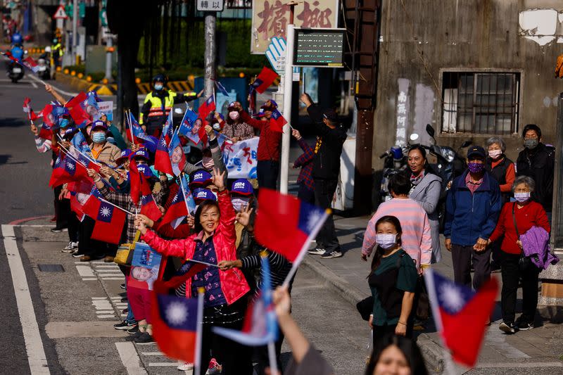 FILE PHOTO: Supporters of Hou Yu-ih, a candidate for Taiwan's presidency from the main opposition party Kuomintang (KMT), wait for him on the side of the street during a campaign event