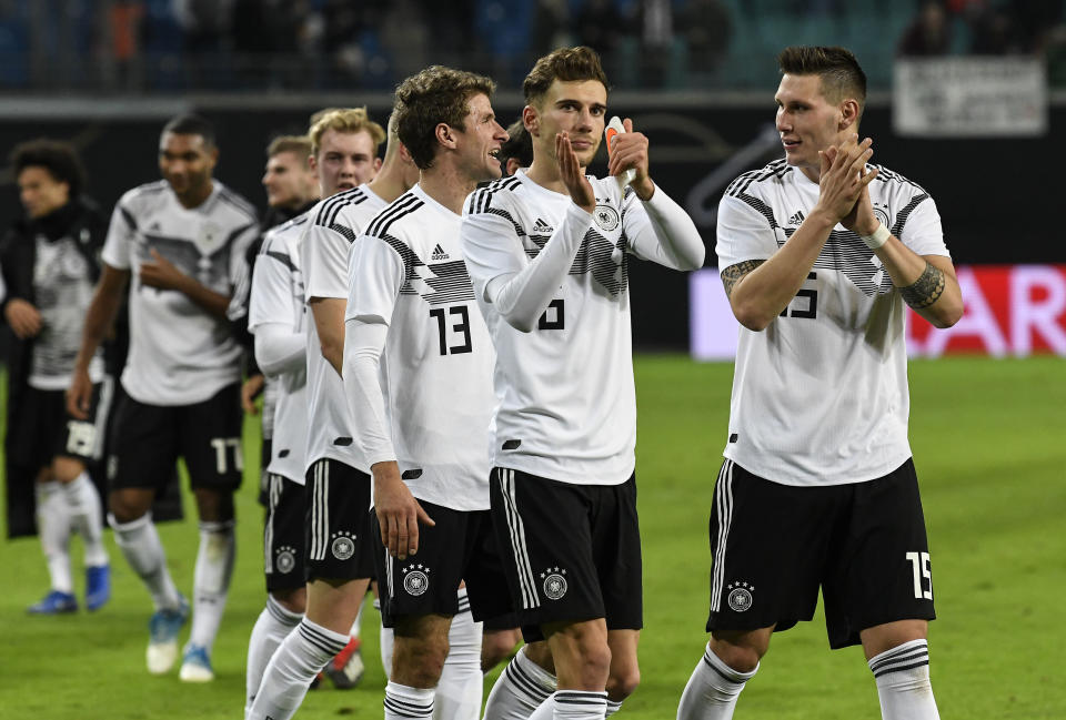 Germany's Niklas Suele, Leon Goretzka and Thomas Mueller, from right, claps hands to supporters after winning a friendly soccer match between Germany and Russia in Leipzig, Germany, Thursday, Nov. 15, 2018. (AP Photo/Jens Meyer)