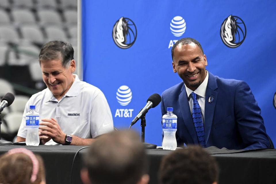 Dallas Mavericks NBA basketball team owner Mark Cuban, left, laughs with new general manager Nico Harrison during a press conference formally introducing Harrison and Jason Kidd, not shown, as head coach, Thursday, July 15, 2021, in Dallas. (AP Photo/Matt Strasen)