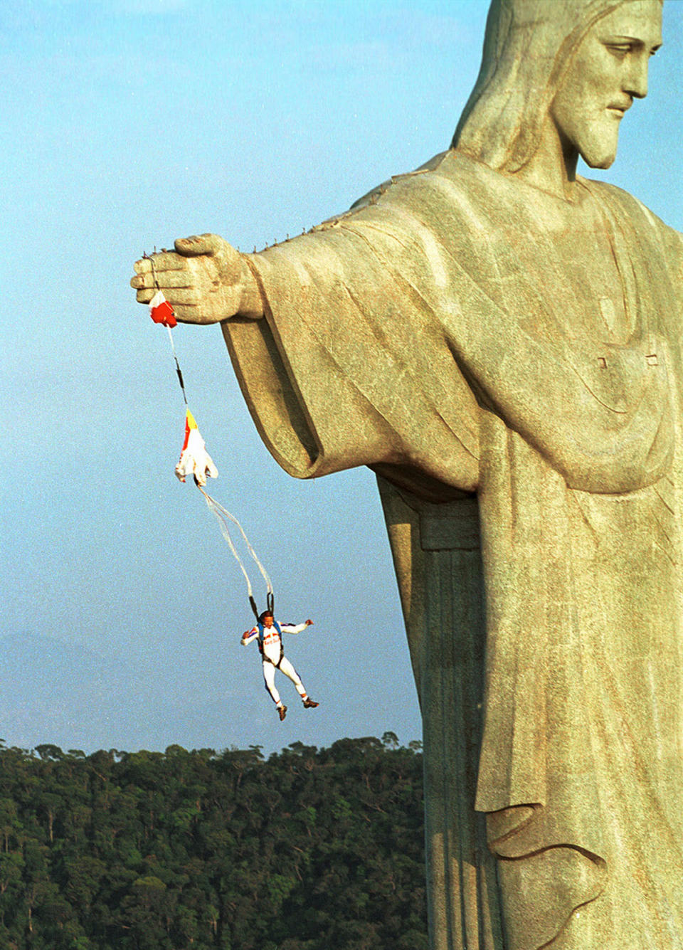 Austrian parachuter Felix Baumgartner, who goes by the code name "Base 502," jumps from the arm of the Christ the Redeemer statue atop Corcovado mountain, overlooking Rio de Janeiro December 1. It is the first-ever known base-jump made from the site. In base-jumping, which is illegal in most countries, parachutists jump from buildings, bridges and earth points like rocks, and the parachute is only pulled open at the very last moment. Baumgartner camped out overnight at the site and used a high-tech crossbow to shoot over the arm of the 30-meter-high statue to climb up. The statue and mountain are located 747 meters above sea level. Reuters