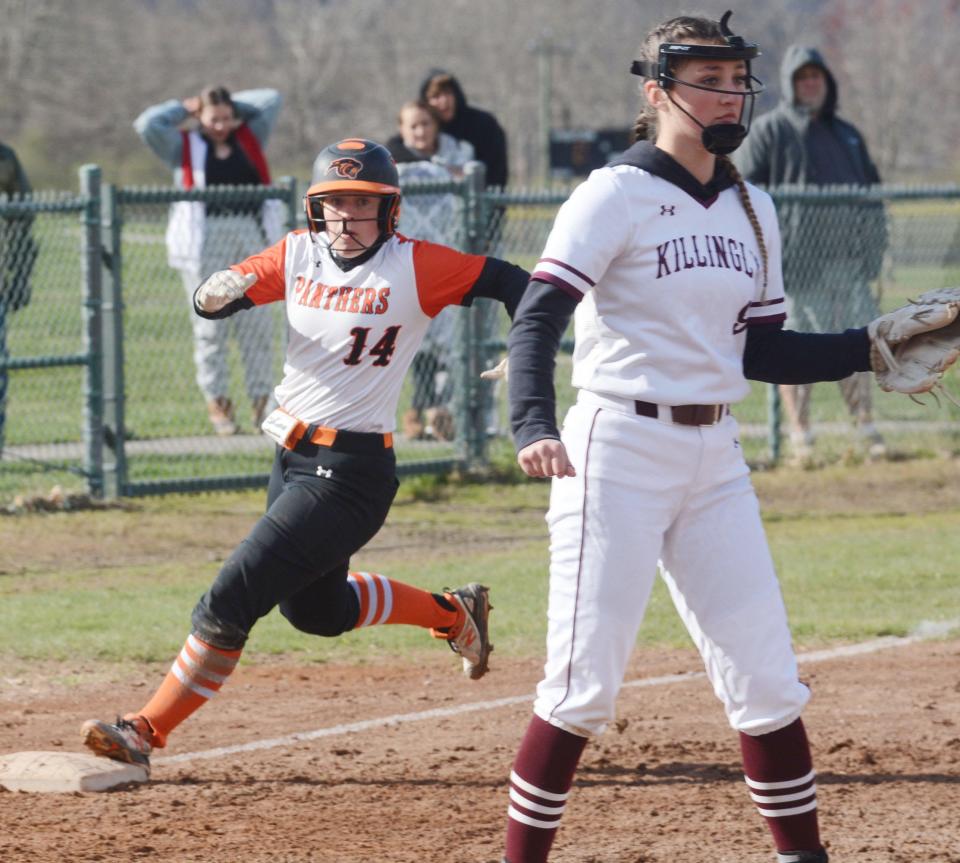 Plainfield's Hannah Irons holds up at third while Killingly's Lyana Cuevas-Bott waits for the relay in Plainfield.