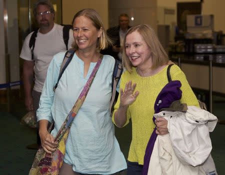 Dr. Stacy Addison (L) is greeted by her mother Bernadette Kero (R) as she arrives at Portland International Airport after being detained for six months in East Timor March 4, 2015. REUTERS/Steve Dipaola